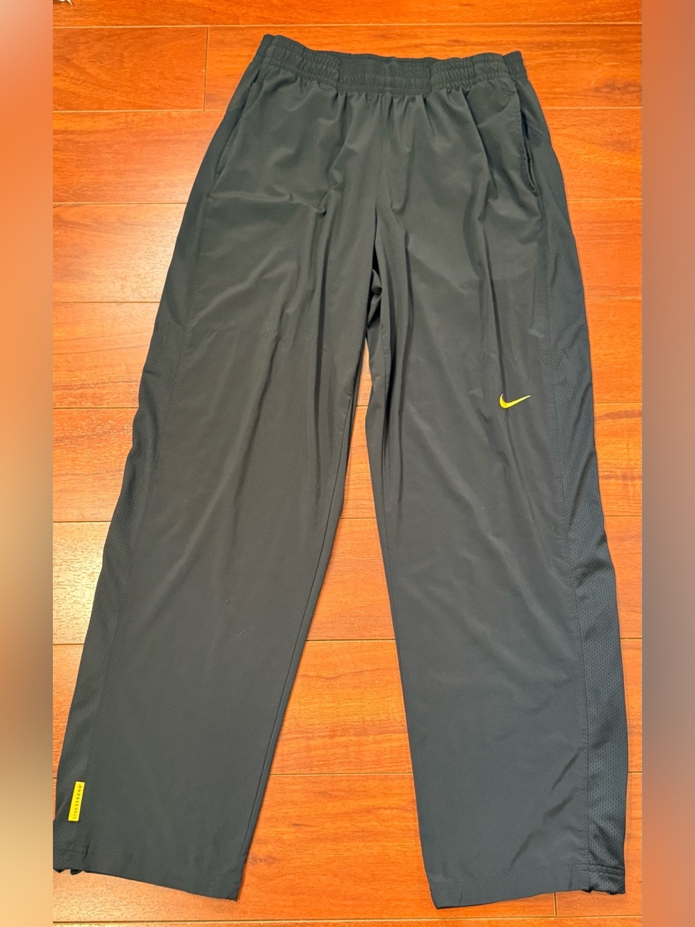 Nike Men's Black Track Pants with Yellow Swoosh
